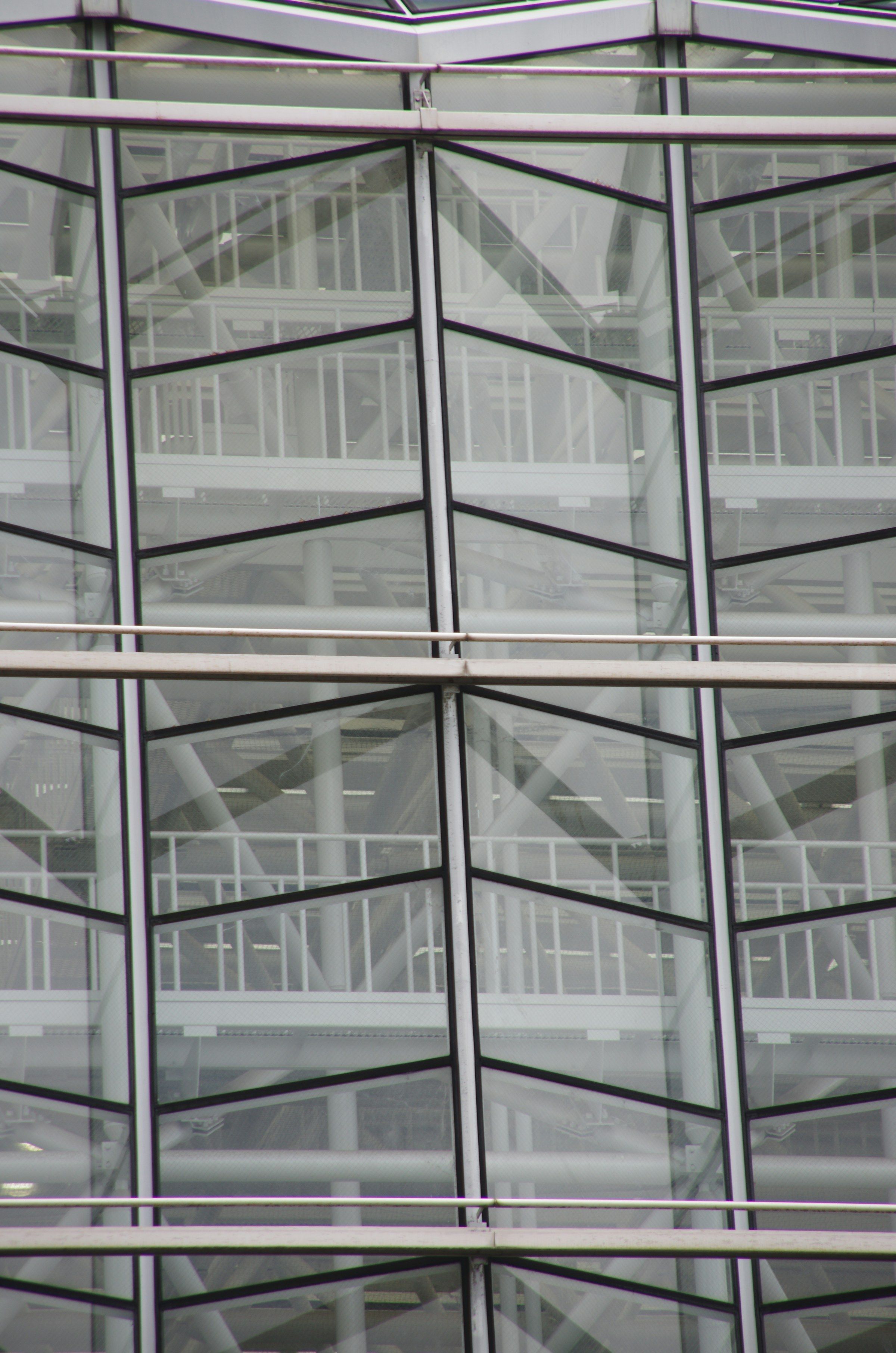 Glazed façade with a geometric steel structure behind it