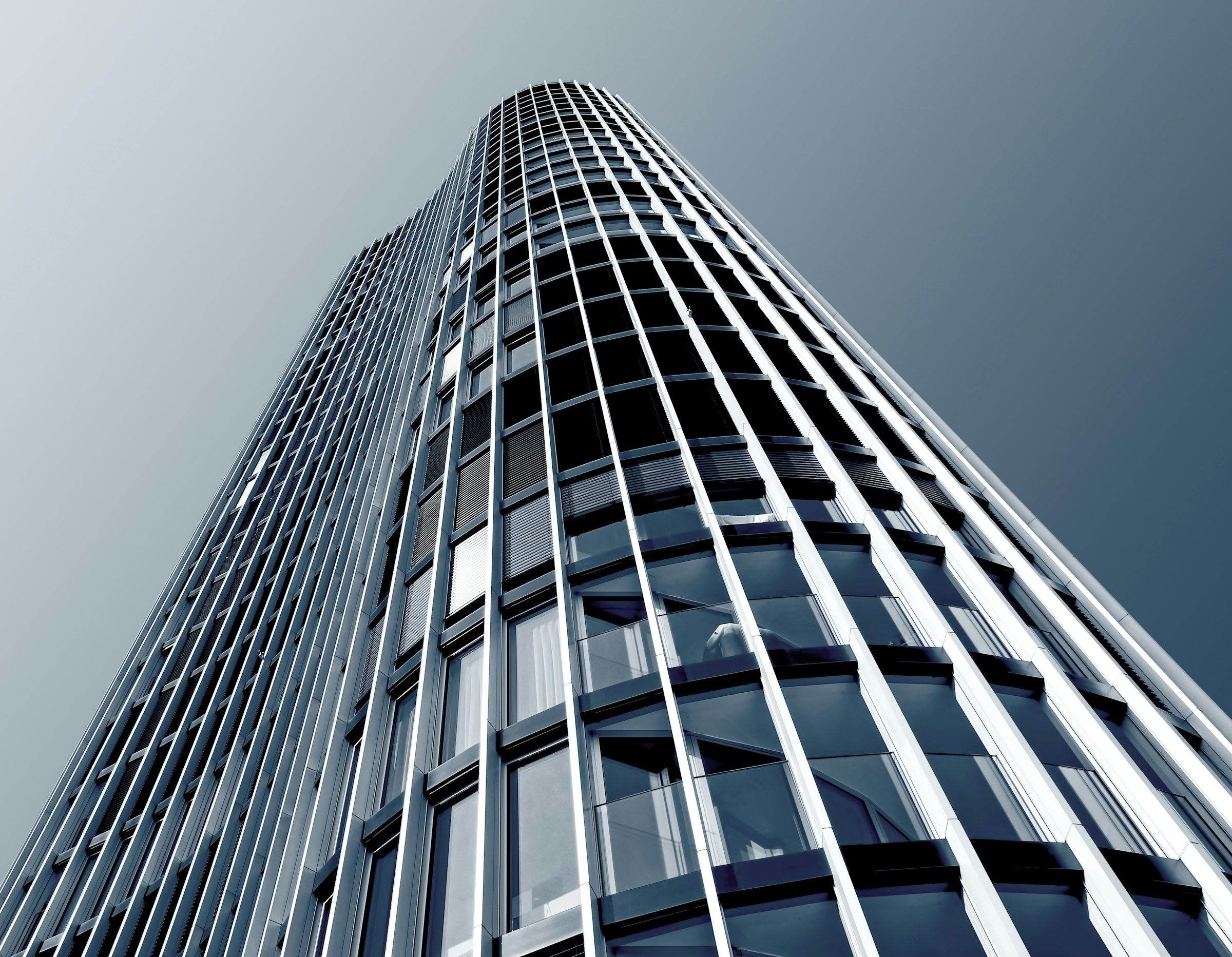 Curtain-wall tower with slim steel mullions, seen from below