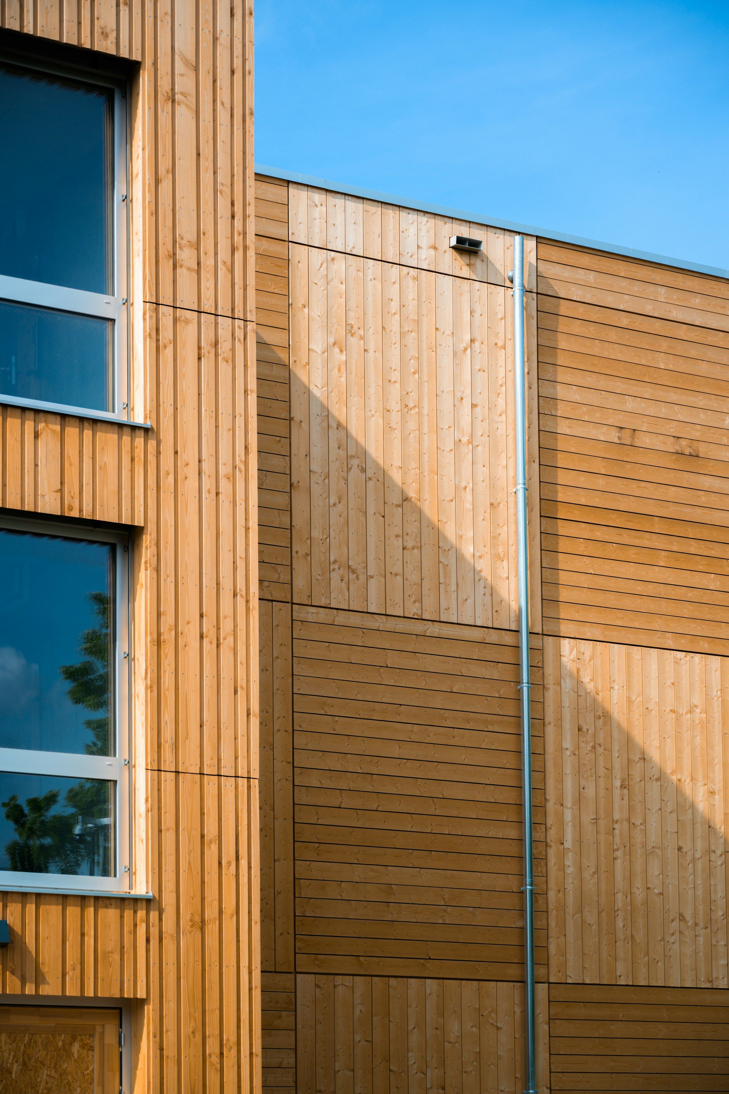 Timber façade panels with strong diagonal shadows